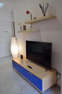 a flat screen tv sitting on top of a blue cabinet at Residence Verbena in Rimini