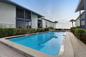 a swimming pool in front of a building at Gulf Place in Holmes Beach