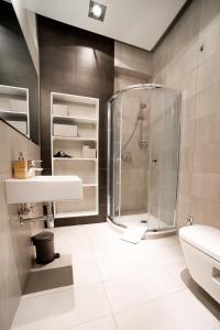 a bathroom with a shower and a sink at Lost In Krakow Mostowa in Kraków