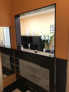 een badkamer met een grote spiegel en een wastafel bij Domus La Foce Hotel Self check in in Genua