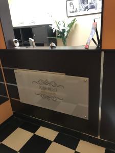 a reception desk with a mirro sign on the door at Domus La Foce Hotel Self check in in Genoa