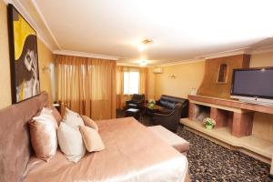 a hotel room with a large bed and a flat screen tv at Atlantic Hotel - Free Parking in Sofia