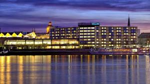 a large building next to the water at night at Appartement Altstadt Mainz in Mainz