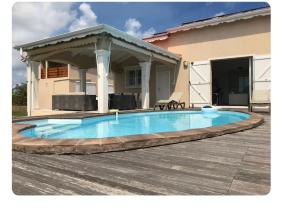 a swimming pool in the middle of a patio at Loft Paradis in Sainte-Anne +30 photos