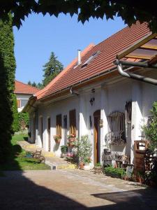 a small white house with a red roof at Sziget Vendégház in Kőszeg