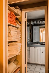 a closet with towels and a sink in a kitchen at The BoatHouse in Marco Island