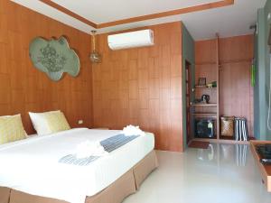 a bedroom with a large bed in a room at Koh Ngai Paradise Beach in Ko Ngai