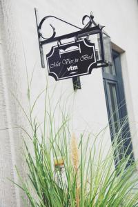 a sign hanging on the side of a building at Bed and breakfast Mooi Achel in Achel +8 photos