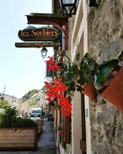 a building with flowers hanging on the side of it at Les Sorbiers Barèges in Barèges
