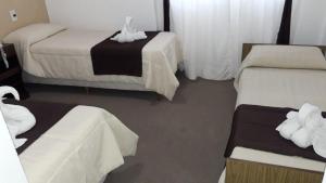 Una cama o camas en una habitación de Alfil Hotel