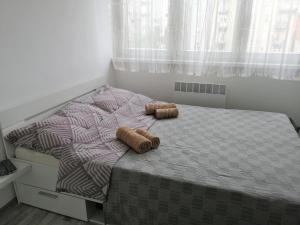 a bedroom with a bed with two wooden logs on it at Ruby room in Zagreb