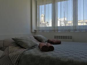 a bed with two pillows on it in a bedroom at Ruby room in Zagreb