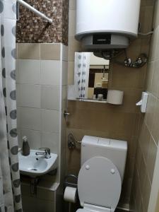a small bathroom with a toilet and a sink at Ruby room in Zagreb