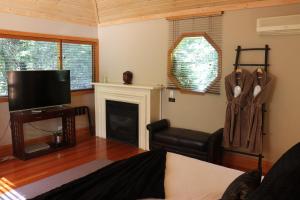 
A television and/or entertainment center at Linden Gardens Rainforest Retreat
