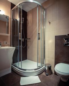 a bathroom with a shower with a toilet and a sink at Golden Lakes Rooms in Plitvička Jezera