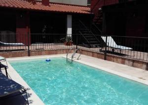 a swimming pool with blue water in a building at Hotel Las Chirimoyas in Salta