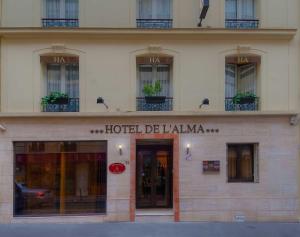 a building with a sign on the front of it at Hôtel de l'Alma Paris in Paris