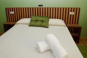 A bed or beds in a room at Hotel Villa De Ribadeo