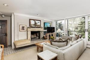 a living room with a couch and a fireplace at Durant Unit B202, Spacious Condo with Great Views, Excellent Location 2 Blocks to Ski Slopes in Aspen