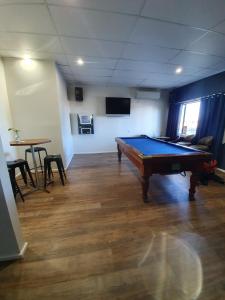 a room with a pool table in a room at Terminus Hotel in Coonamble