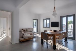 a living room with a table and a couch at Parikia's Crossroad 3 Bedroom House in Kampos Paros
