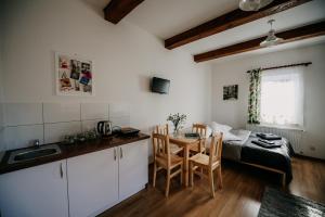 a kitchen and dining room with a table and a bed at Piękne Roztocze in Zamość