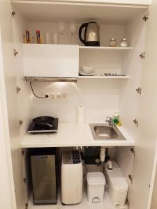 a small kitchen with a sink and a counter at Binder-Home Stylish Studios Budapest/Parliament in Budapest