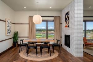 a dining room with a table and chairs and a fireplace at Juniper Preserve in Bend