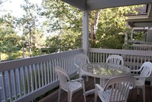 a table and chairs on the porch of a house at JHRL - Teton Pines Townhome #20 in Wilson