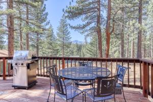 a table and chairs on a deck with a grill at Tallac Views Getaway in South Lake Tahoe