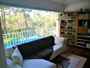 a living room with a couch and a large window at Villa Colares in Sintra