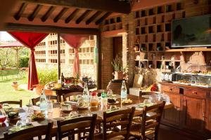 a long table with chairs and bottles on it at Agriturismo Casa VolaterrA in Volterra