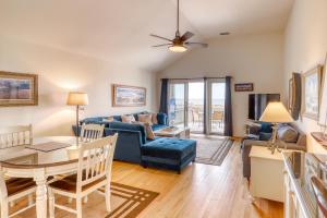 a living room with a blue couch and a table at 1378 Pelican Watch Villa in Seabrook Island