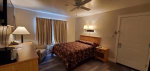 a hotel room with a bed and a couch at Bridge Street Inn in Baker City
