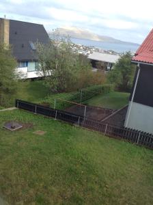 a view of a yard with a fence at Marna Guesthouse doubleroom nr.2 in Tórshavn