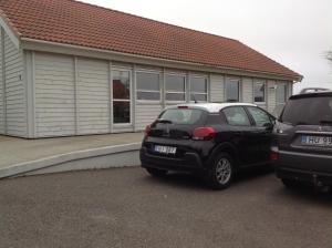 two cars parked in front of a house at Marna Guesthouse doubleroom nr.2 in Tórshavn