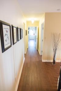a hallway of a home with wood floors at Butterfly Manor in Niagara Falls