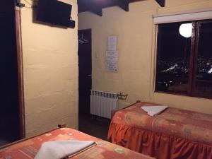 a hotel room with a bed and a window at Samay Wasi Hostel I in Cusco