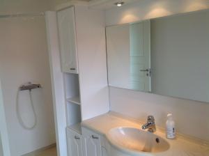a bathroom with a sink and a mirror at Marna Guesthouse doubleroom nr.2 in Tórshavn