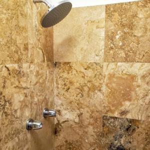 a shower with a shower head in a bathroom at KASA Roof Top 5 1 Bed 1 Bath Rooftop in San Juan