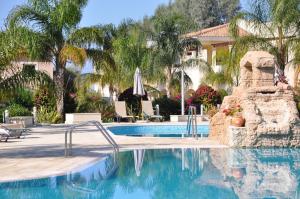 een zwembad in een resort met palmbomen bij 2 Bed, 2 Bath Apartment In Mandria in Mandria