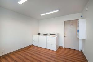 an empty room with white walls and wooden floors at Motel 6-Odenton, MD - Fort Meade in Odenton