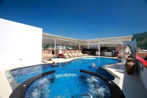 a large swimming pool with people in the water at Absolute Bangla Suites in Patong Beach