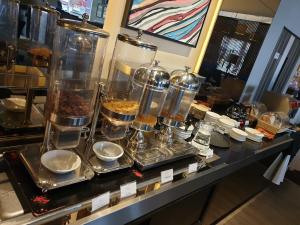 a buffet of food on a counter in a restaurant at Abell Hotel in Kuching +45 photos