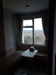a room with a small table and a window at ENVIRO Studio in Cikarang