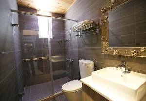 a bathroom with a shower and a toilet and a sink at GuiZhuLin B&B in Jiaoxi