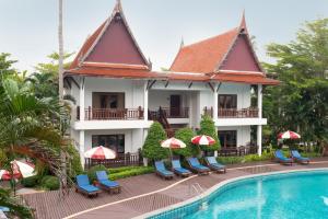 a resort with a swimming pool and a building at Royal Lanta Resort & Spa in Ko Lanta