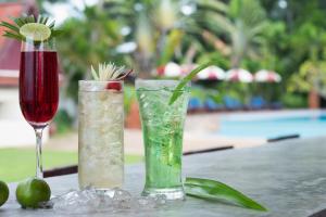 two vases sitting on top of a table with drinks at Royal Lanta Resort & Spa in Ko Lanta