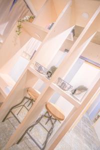 an open staircase with two stools in a house at AMP FLAT Nishijin 2 in Fukuoka