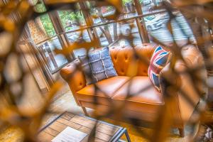 an overhead view of a living room with two leather chairs at AMP FLAT Nishijin 2 in Fukuoka